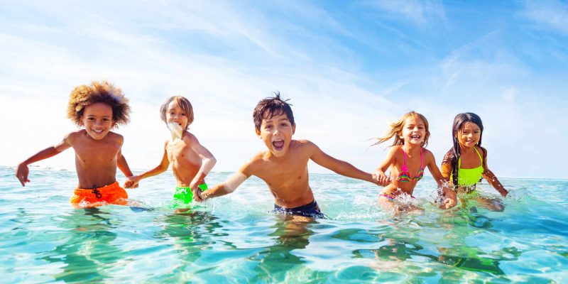 Kids,Laughing,And,Playing,In,Water,At,The,Seaside