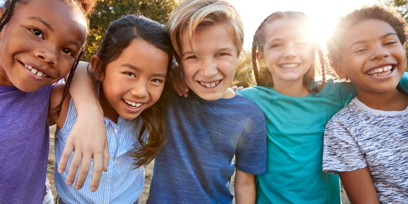 Portrait,Of,Multi-cultural,Children,Hanging,Out,With,Friends,In,Countryside