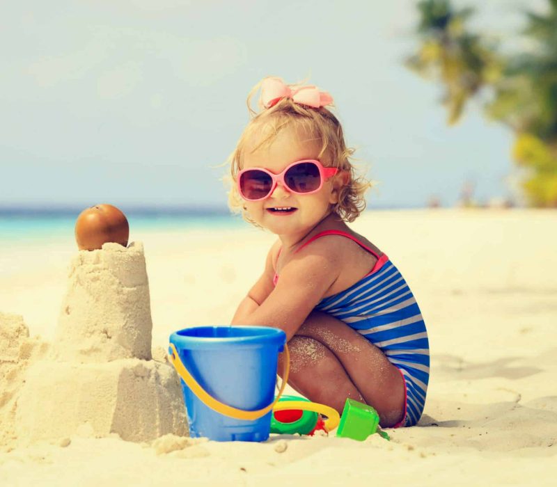 Cute,Little,Girl,Playing,With,Sand,On,Tropical,Beach